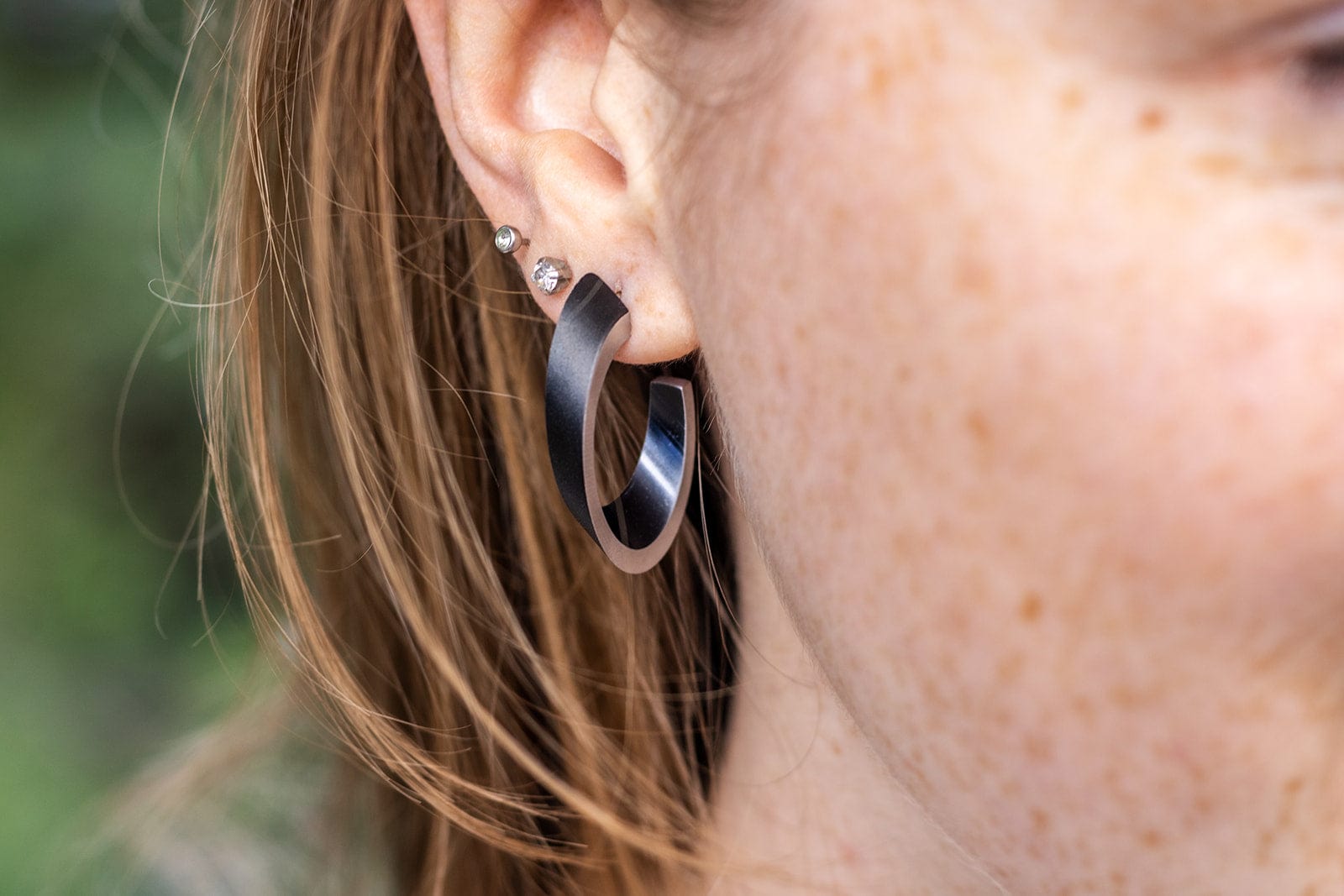OLIVIA black earrings worn | oval hoop earrings with a matte finish | CLIC by Suzanne