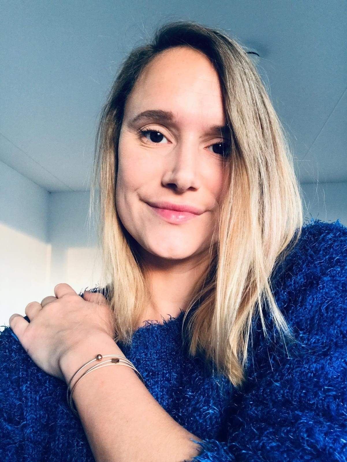 Woman wearing Thinking of You bracelet with gold-tone star charm | CLIC by Suzanne